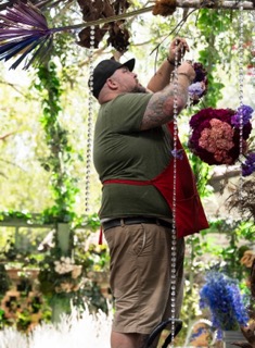 ace installing hanging floral arrangements